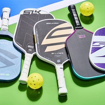 Pickleball paddles and balls on a colorful background.