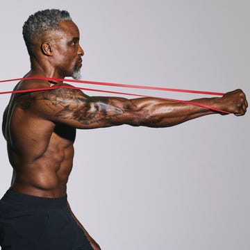 Person performing an exercise with resistance bands.