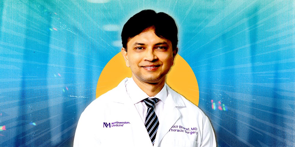 Medical professional in a white coat with a blurred face.