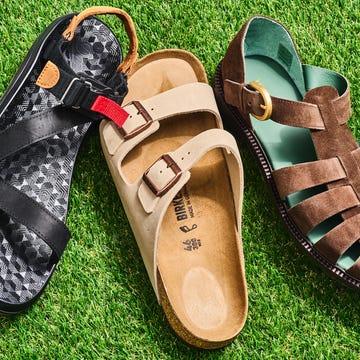 Three different styles of sandals on grass.