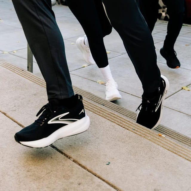 People running on a pavement wearing contemporary athletic shoes. People running on a pavement wearing contemporary athletic shoes.