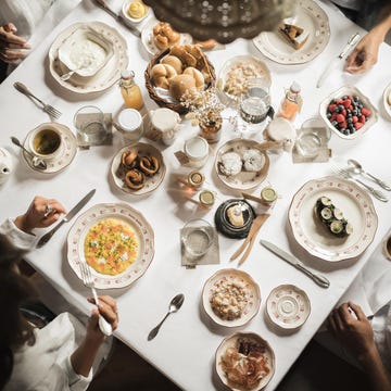 dining table set with various breakfast foods