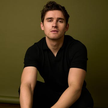 Male crouching against a green background. Male crouching against a green background.