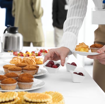woman taking snack during coffee break, closeup