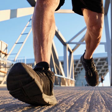 Person jogging on a textured surface near a modern structure. Person jogging on a textured surface near a modern structure.