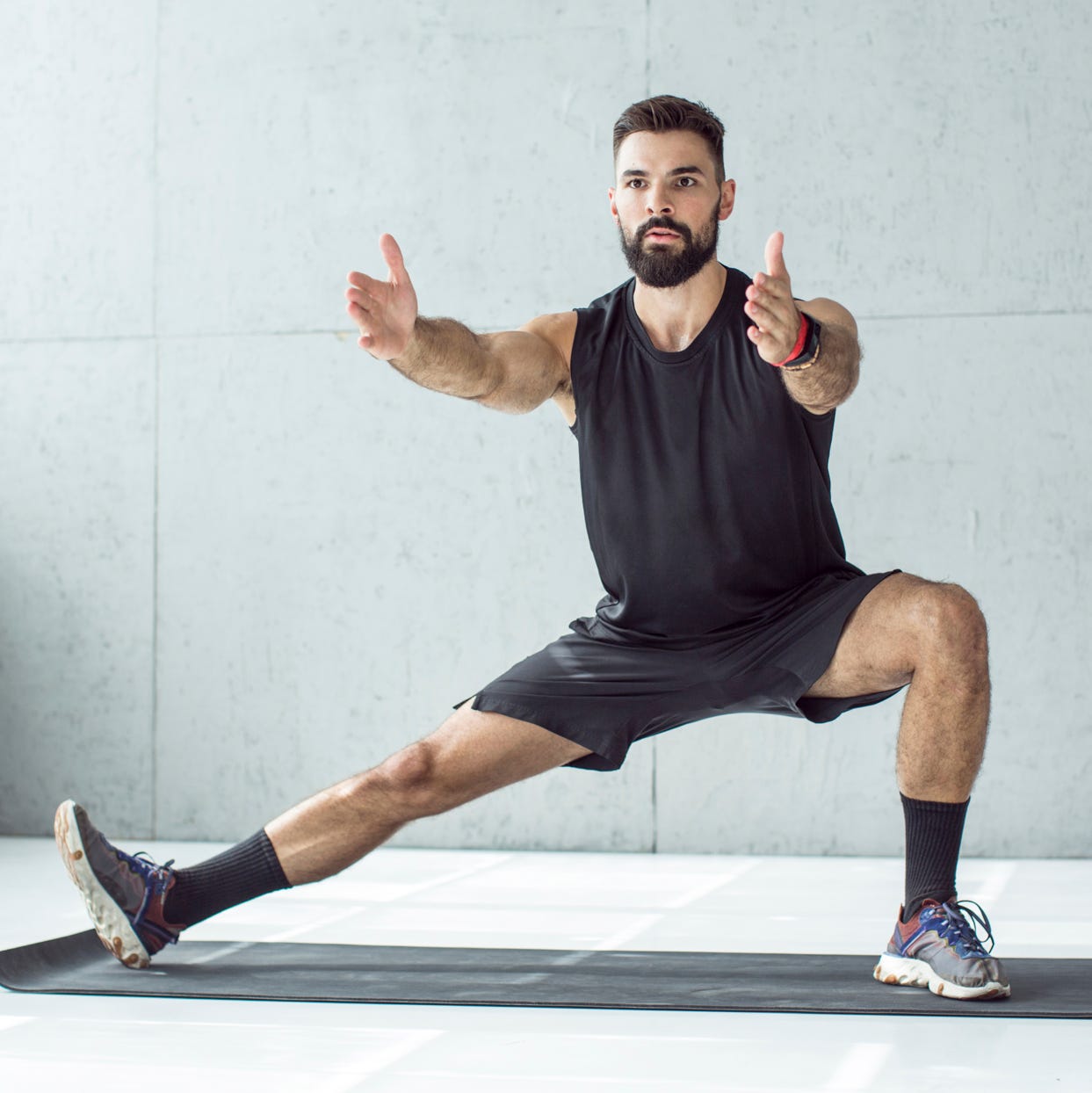 young men exercising in gym focusing on total body strength