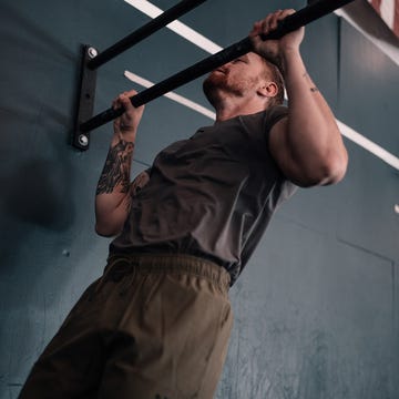 Individual performing a pull-up on a bar.