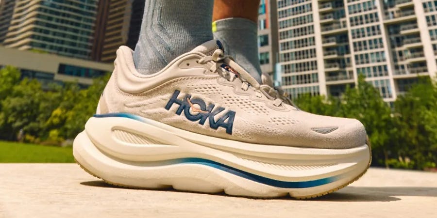 Close-up of a sneaker outdoors with a city skyline in the background. Close-up of a sneaker outdoors with a city skyline in the background.