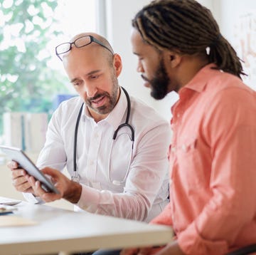 doctor giving consultation to patient using digital tablet