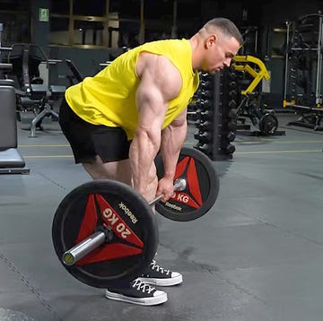 person performing a deadlift in a gym