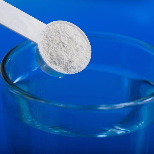 Sport supplement, creatine, hmb, bcaa, amino acid or vitamin - mesure with powder over a glass of water. Sport nutrition concept. sport supplement, creatine,