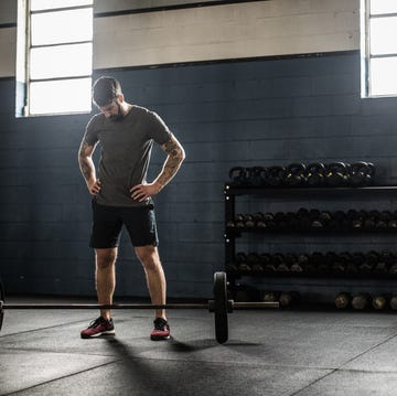 man resting in between sets at cross training gym