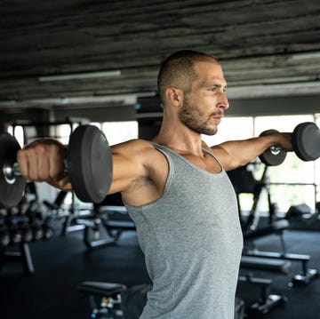 individual performing a weightlifting exercise in a gym