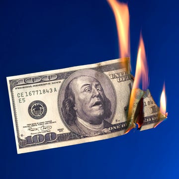 burning money on blue background