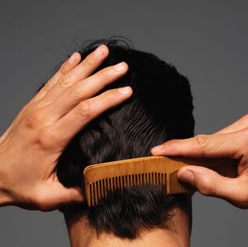 Combing hair with a wooden comb