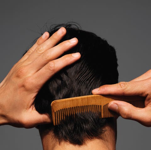 Combing hair with a wooden comb