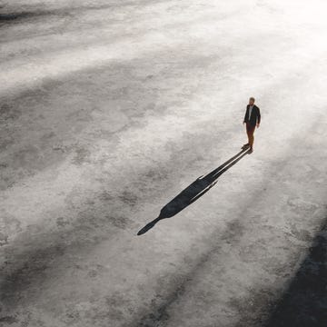 solitary man walking in vast empty space.