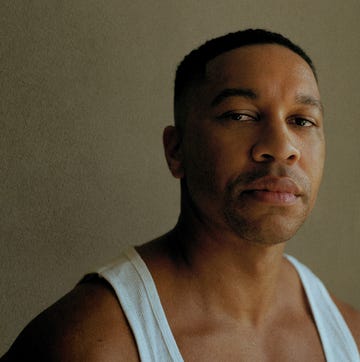 portrait of a man with a blurred face wearing a white tank top against a neutral background