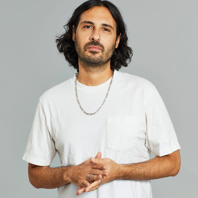 a man with a beard and a necklace