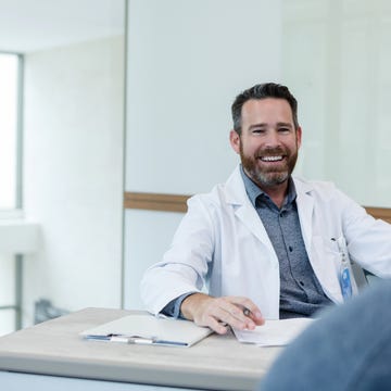 male doctor gives unrecognizable patient good news