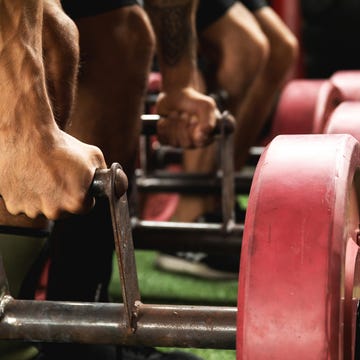 Male hands with a weights for farmer's walk exercise