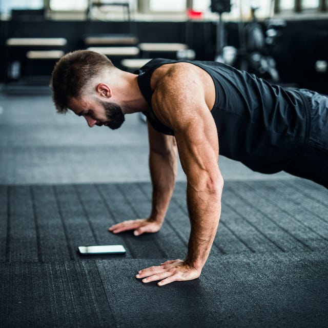man using phone in a gym