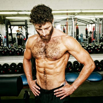 male athlete posing with a muscular physique in a gym setting male athlete posing with a muscular physique in a gym setting