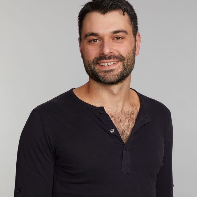 portrait of a man wearing a black longsleeve shirt