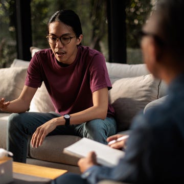 male therapist listening to a man talk on a private therapy session.