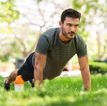 young man doing push up exercises in the park